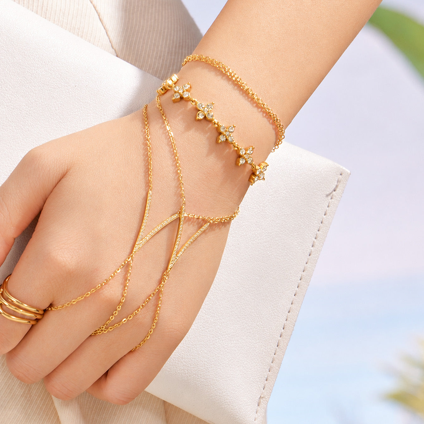 Gold zircon hand chain bracelet stacked with butterfly zircon bracelet on wrist, summer hand jewelry styling by Miduoduo Jewelry