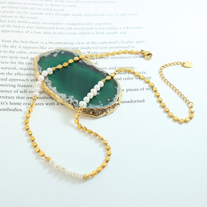 Minimalist gold freshwater pearl necklace flat lay with pearl splice design for boutique necklace assortments