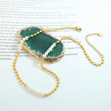 Minimalist gold freshwater pearl necklace flat lay with pearl splice design for boutique necklace assortments