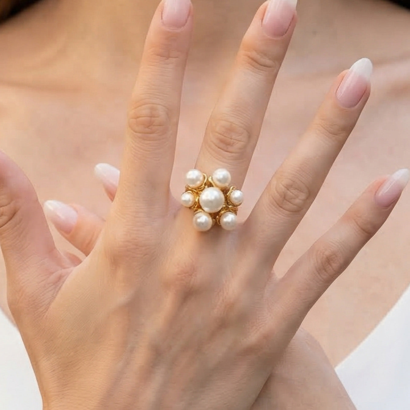 Minimalist gold open pearl ring worn on a model hand