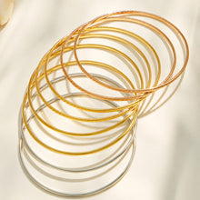 Slim stainless steel stackable bangles in steel, gold and rose gold-tone finishes