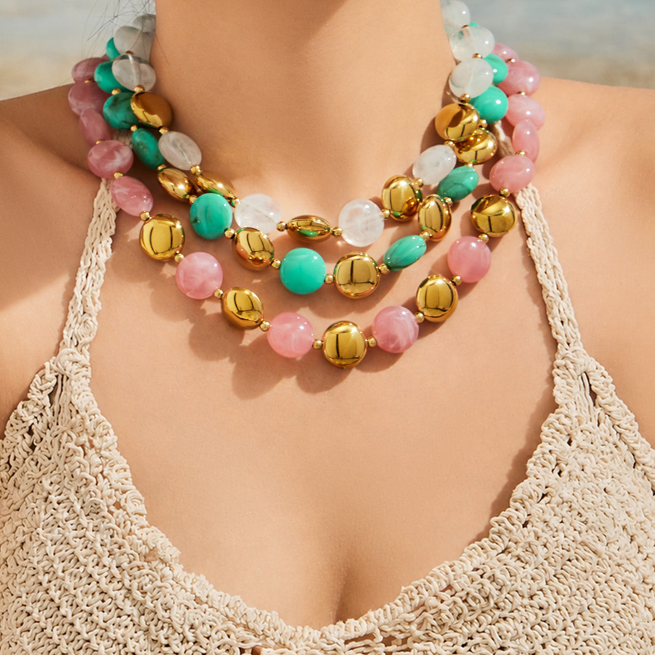 Model wearing a multicolor resin necklace and bracelet jewelry set styled as a bold summer fashion accessory.