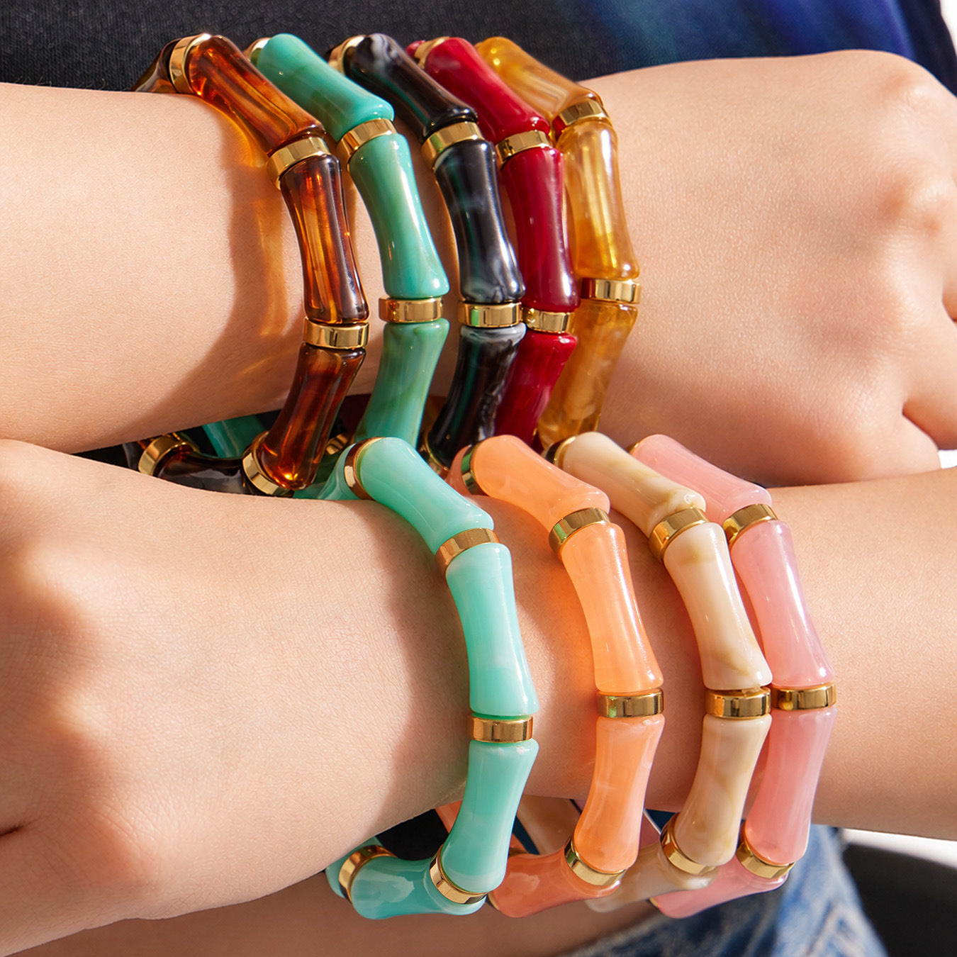 Gold tone resin bamboo bangle bracelet worn on wrist for vacation and summer jewelry styling
