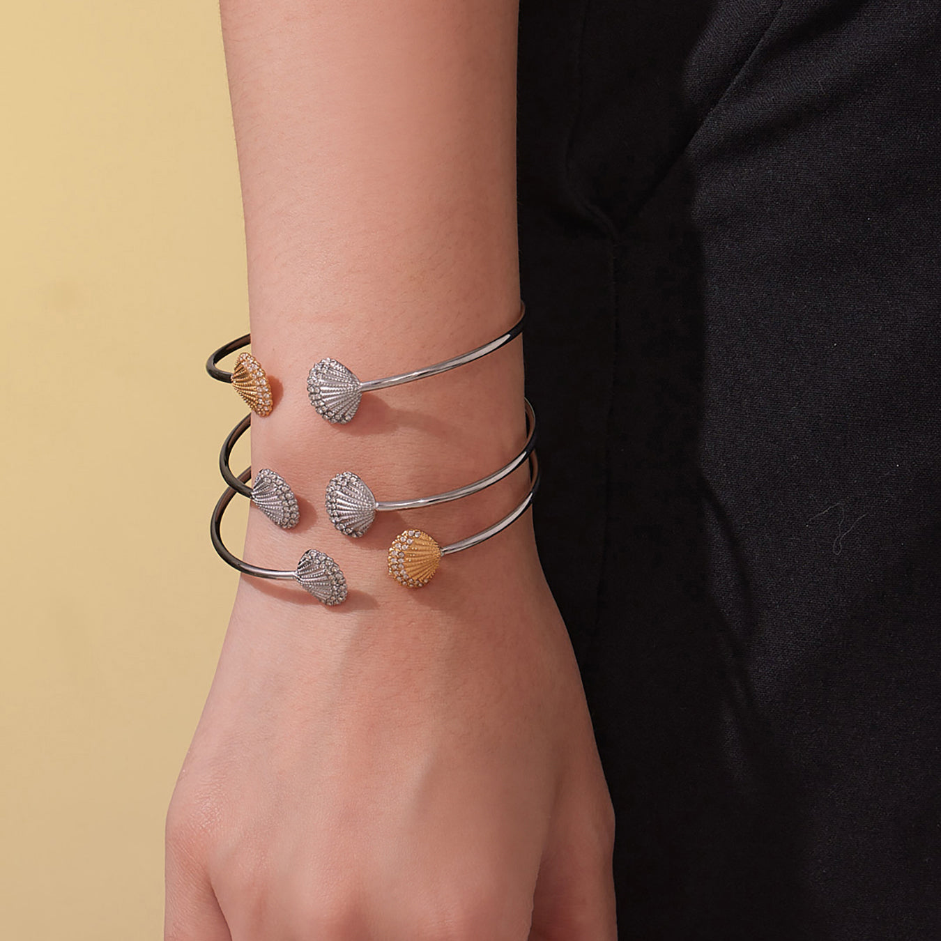 model wearing multi-color shell diamond cuff bracelets, stacked style, casual fashion accessory