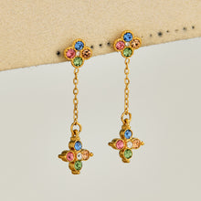 Multicolor cubic zirconia clover drop earrings displayed on a neutral background