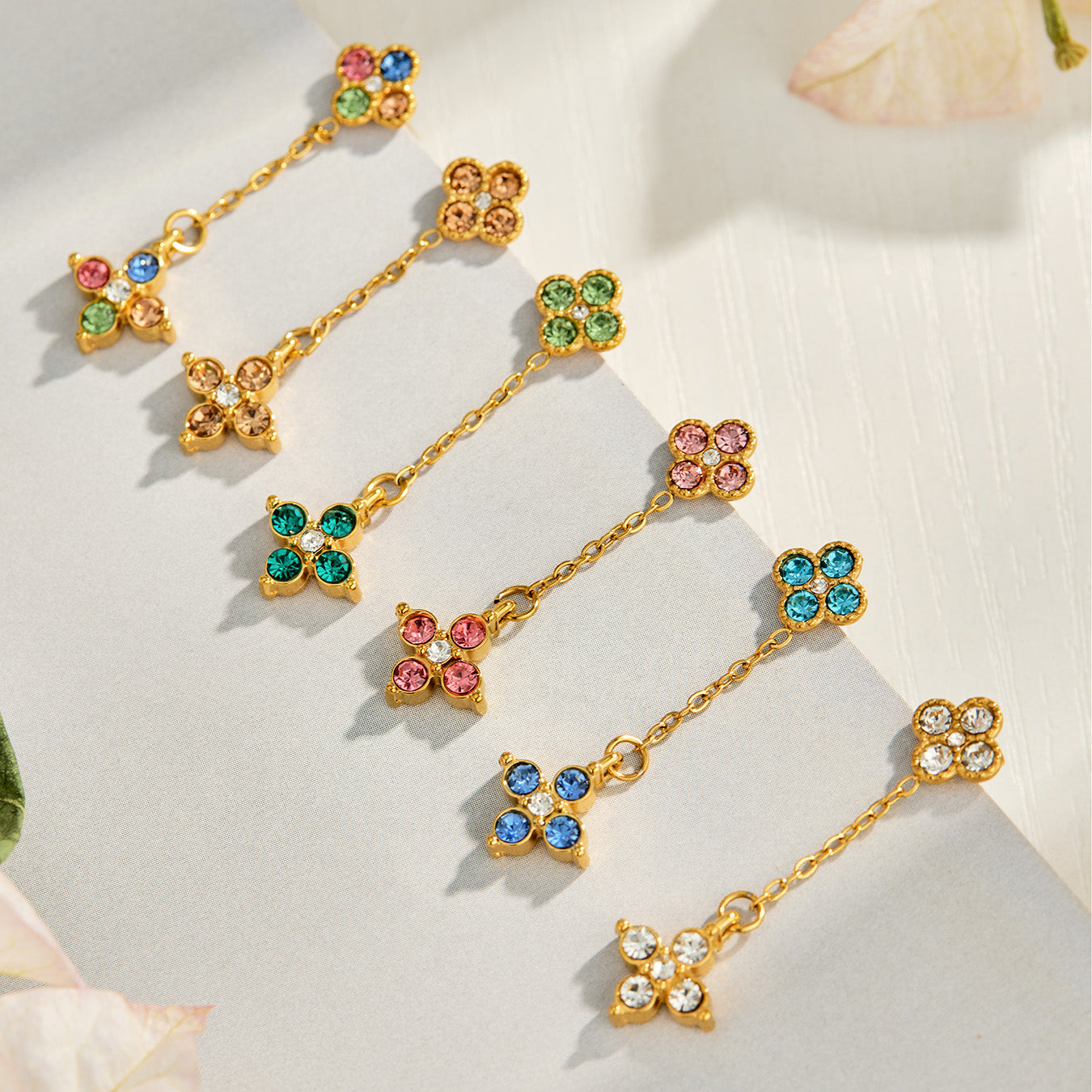 Multicolor clover drop earrings displayed in assorted colorful CZ styles