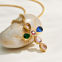 Multicolor faceted stone cross pendant close-up