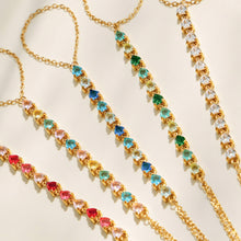 Close-up of multicolor 5A cubic zirconia links on a gold hand chain bracelet