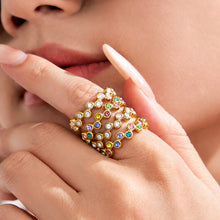 Model wearing a multicolor cubic zirconia statement ring with a wide multi-row design