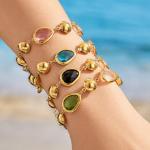 Colorful glass stone bracelets styled on wrist