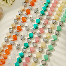 Multiple colorful square resin bead strands displayed together with polished stainless steel accent beads