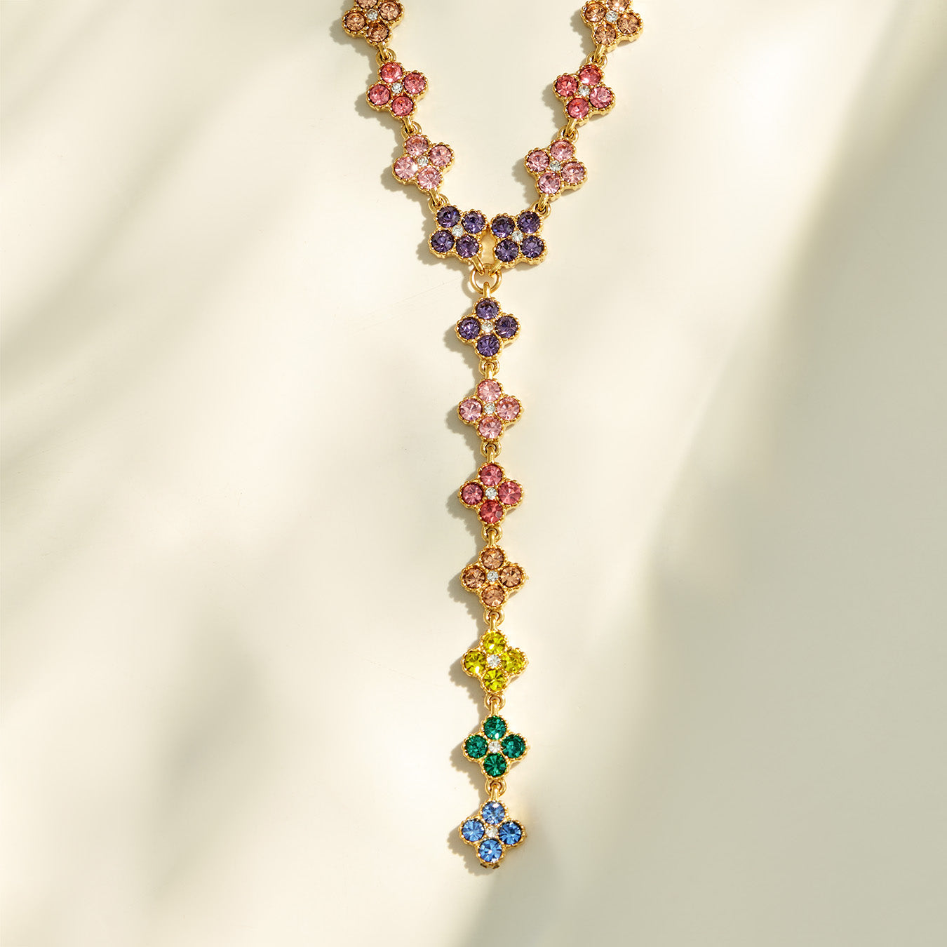 Detailed view of a multicolor zircon Y necklace with an elongated floral drop