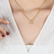Model wearing a delicate natural stone pendant necklace with 18K PVD gold stainless steel chain
