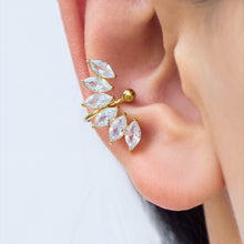 Gold-tone stainless steel leaf ear cuff worn on the ear, featuring clear marquise-shaped stones arranged in a curved pattern