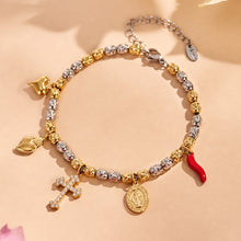 Detail of the charm bracelet showing the gold finish