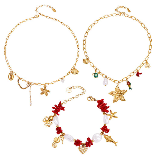 Ocean charm necklace and bracelet collection worn by model with starfish, fish tail, pearl and shell details for wholesale boutique buyers