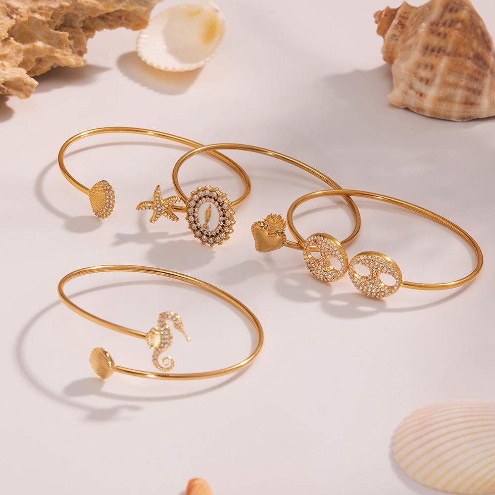 5A zircon ocean bangle set displayed with seashells, beach theme luxury jewelry