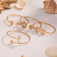 5A zircon ocean bangle set displayed with seashells, beach theme luxury jewelry