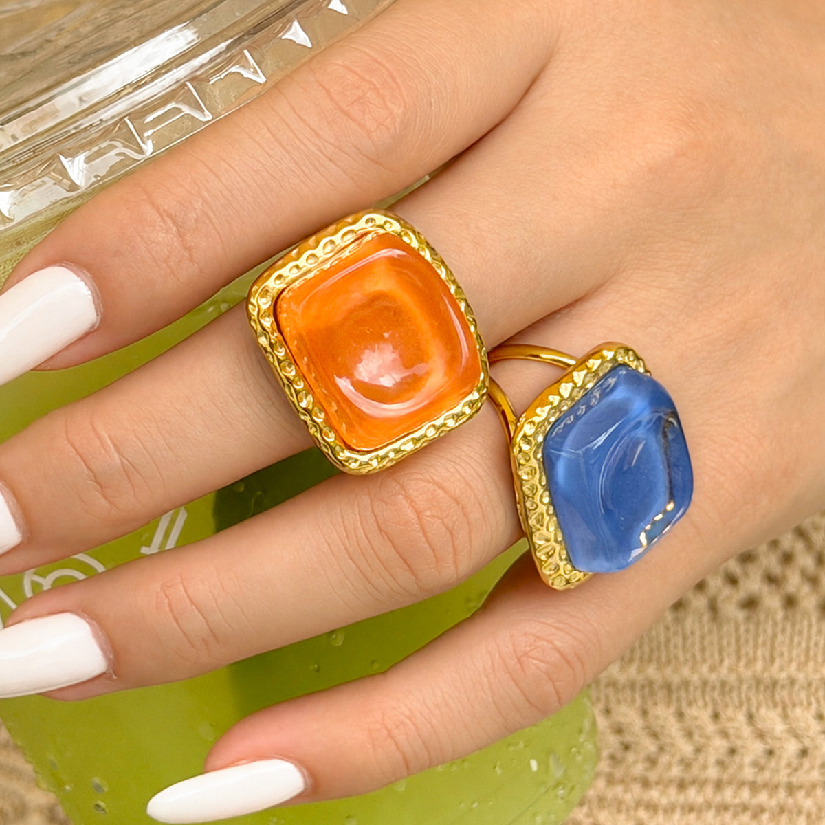 Orange and blue square resin rings with textured gold-tone frames