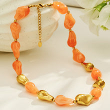 Orange resin necklace and matching bracelet set with organic chunky beads and gold-tone details