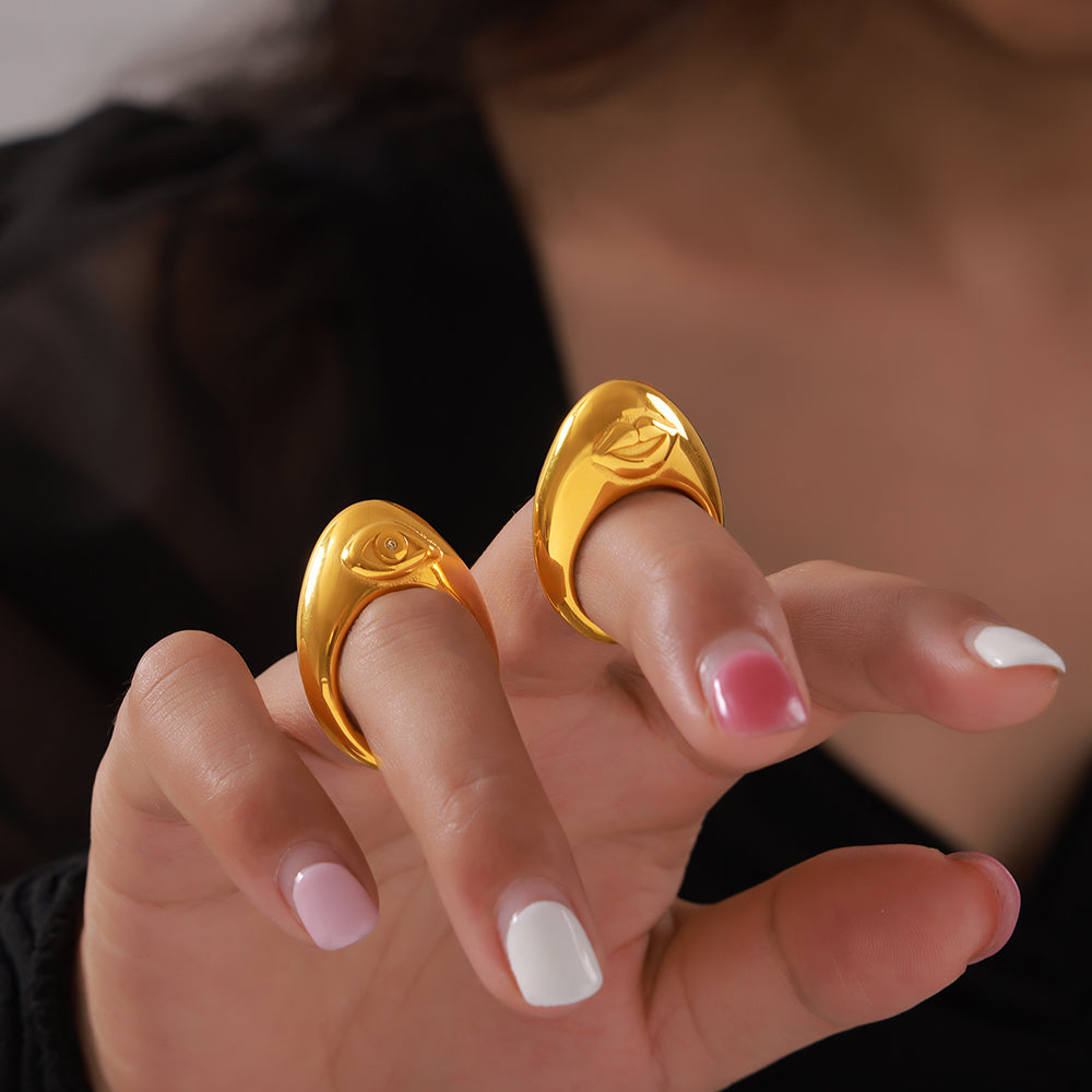 Close-up of gold-tone organic cutout rings worn on a model's fingers