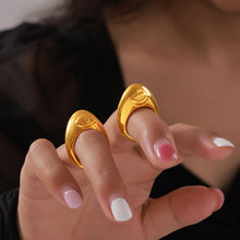 Close-up of gold-tone organic cutout rings worn on a model's fingers