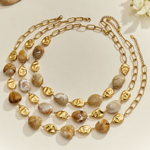 Layered organic resin necklaces with irregular resin beads and gold-tone stainless steel accents displayed together