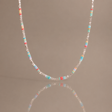 Colorful natural stone beaded necklace with pastel square beads and stainless steel details displayed with soft reflection