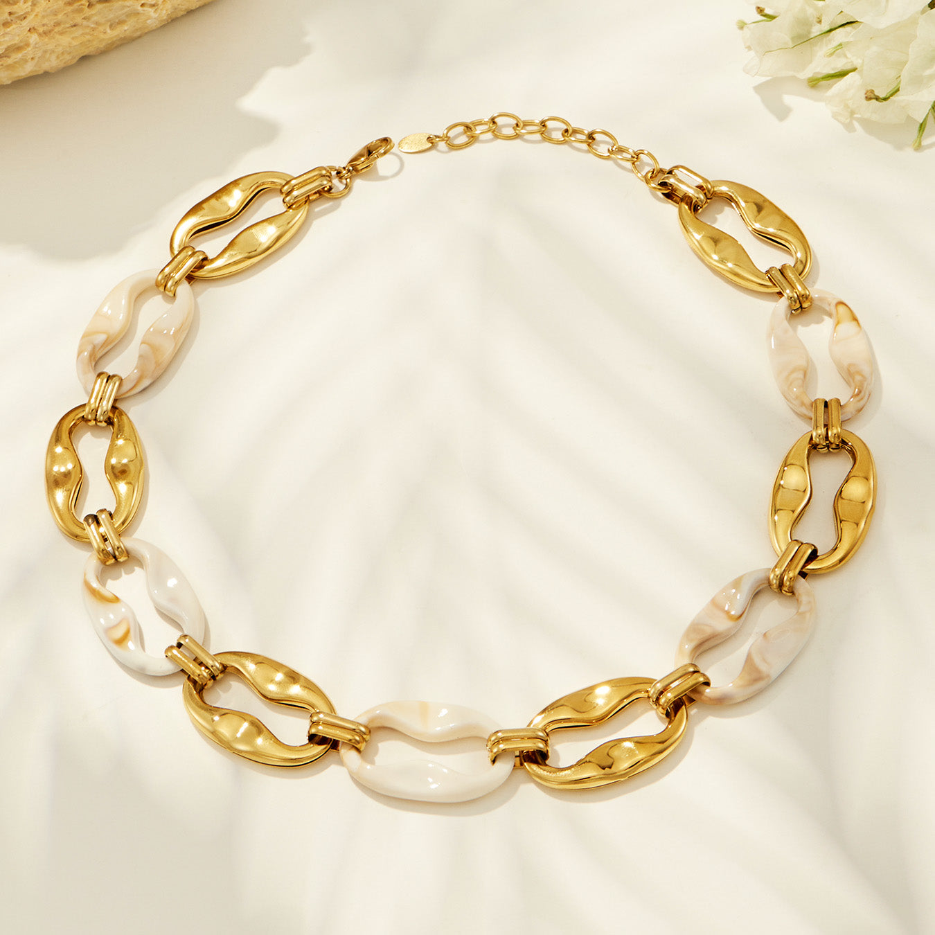 Chunky gold geometric chain necklace with sculptural open links displayed on a light background