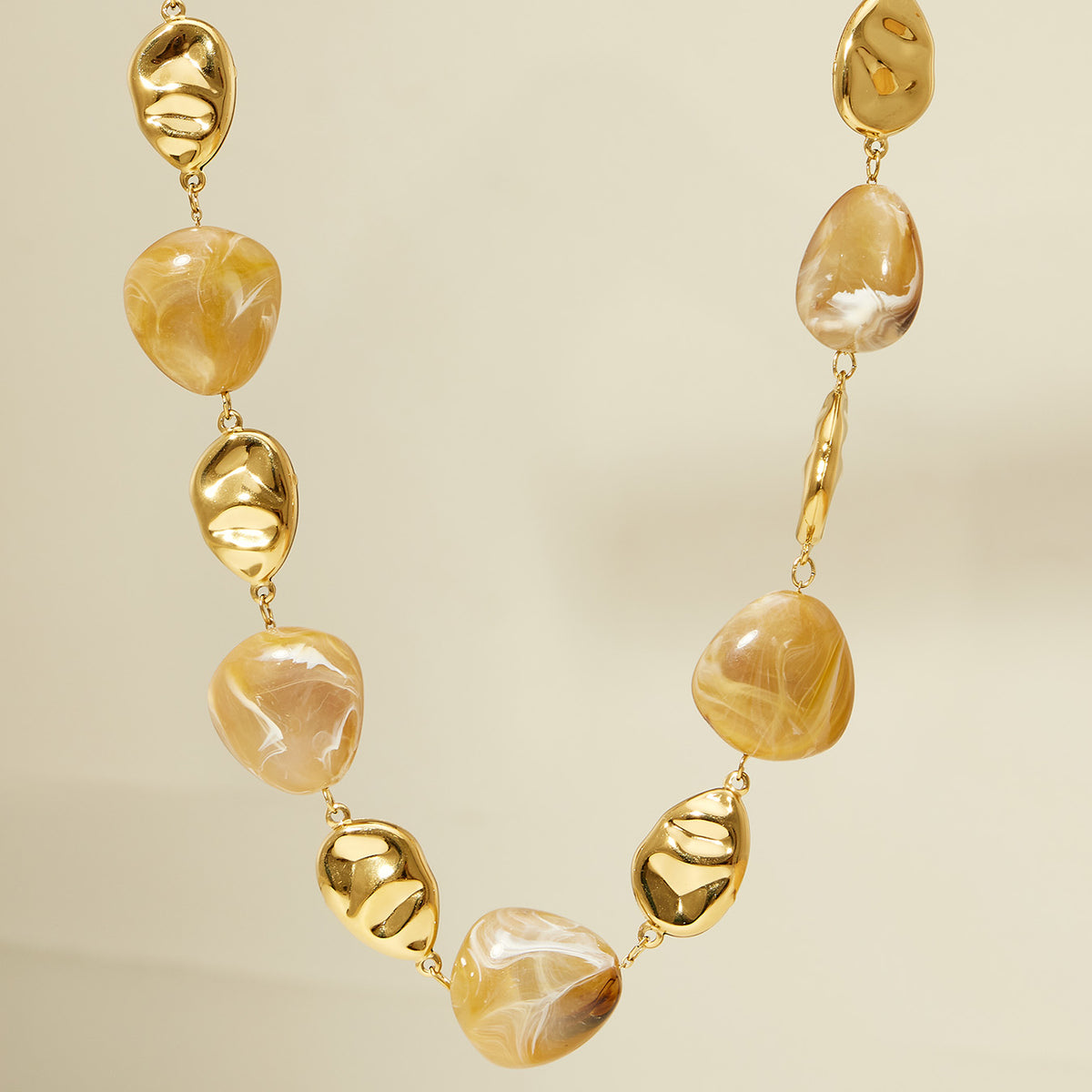 P691 resin bead necklace displayed to show the alternating organic resin and polished gold bead construction
