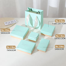 Pastel blue and pink jewelry packaging boxes in multiple sizes for rings earrings bracelets necklaces and jewelry sets