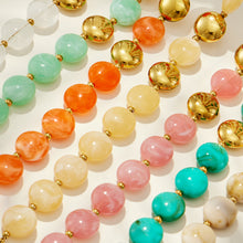 Flat lay of pastel resin bead patterns in assorted colors showing jewelry material and design details.