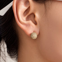 Close-up of pavé zircon ball stud earring worn on model