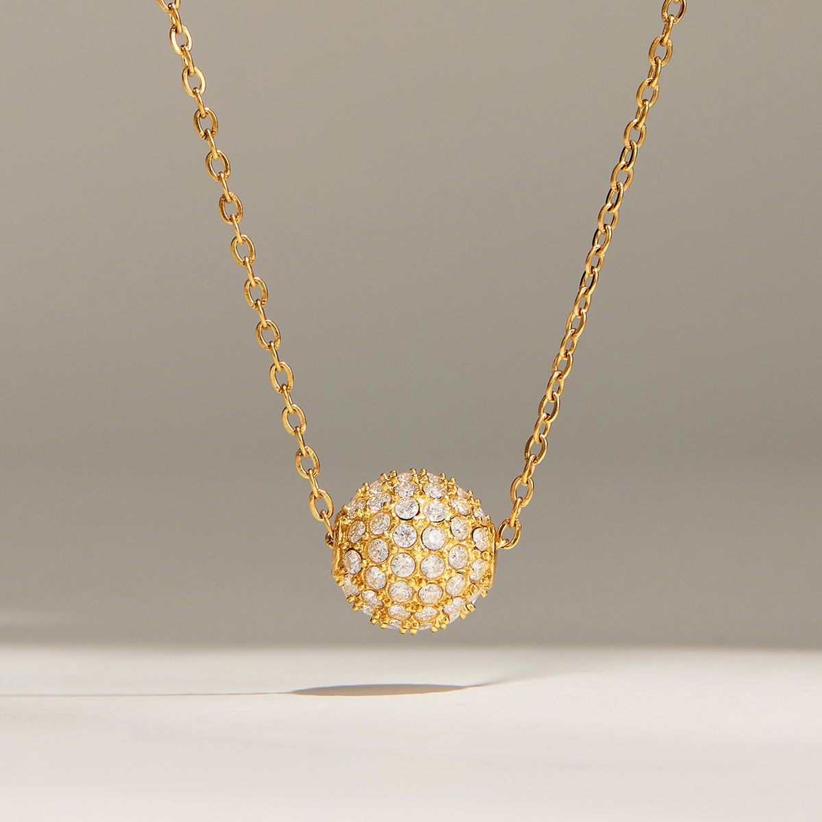 Gold pavé zircon ball necklace with round crystal-covered sphere pendant