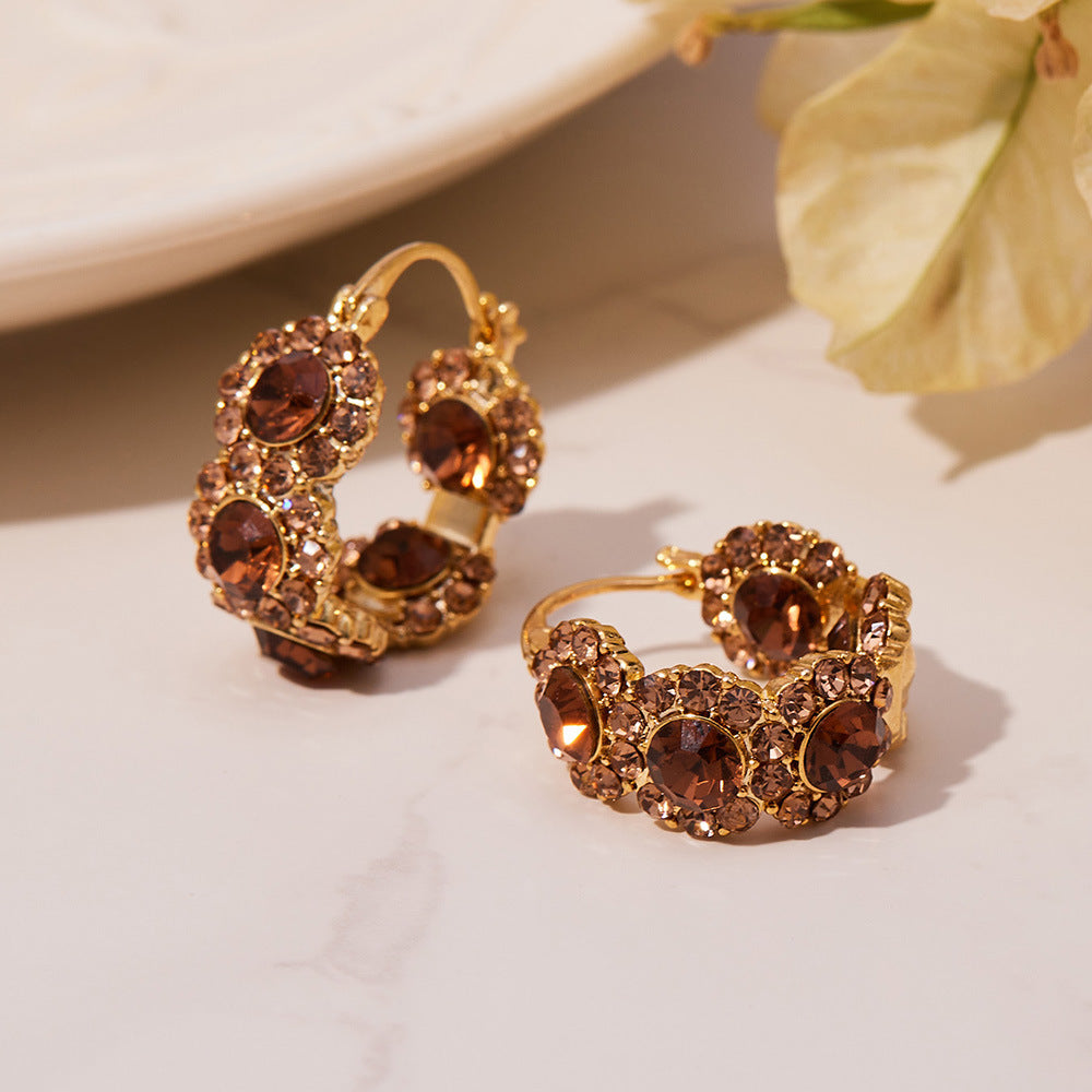 Gold plated copper ear cuff earrings featuring a sculptural U shape and pavé zircon stones
