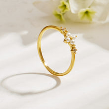 Side view of a pearl accent floral ring in 316L stainless steel with polished 18K PVD gold finish