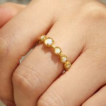 Pearl detail gold ring in 316L stainless steel shown on hand with an elegant soft floral design