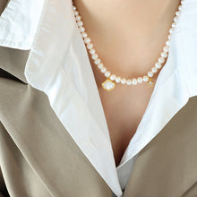 Elegant pearl pendant necklace on display