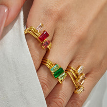 Model wearing pink and green cubic zirconia multi-band gold rings on the hand