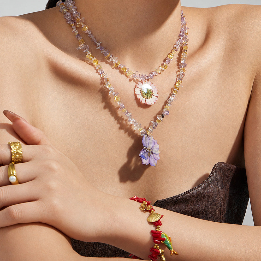 Model wearing purple resin flower crystal bead necklace for feminine summer jewelry styling