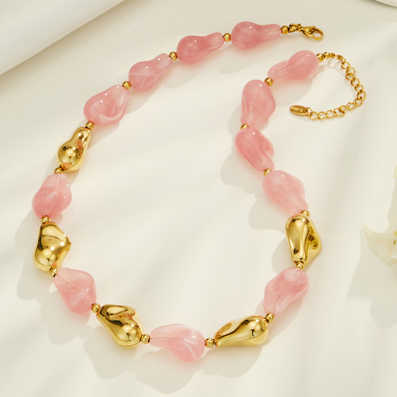 Pink resin necklace and matching bracelet set with chunky organic beads and gold accents