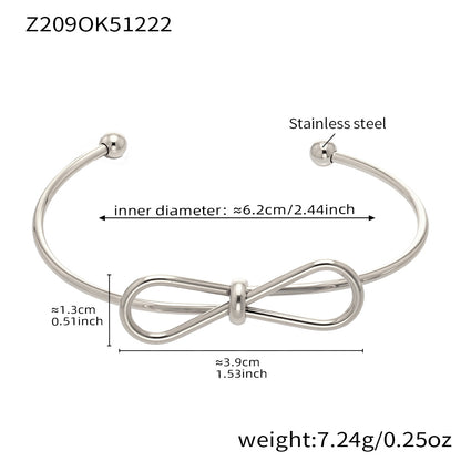 Polished silver stainless steel bow bangle spec view, inner diameter 6.2cm, weight 7.24g