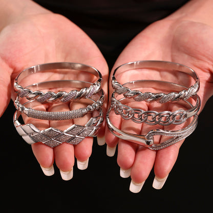 Polished silver stainless steel zircon bangle set held in hands, high-end INS style jewelry