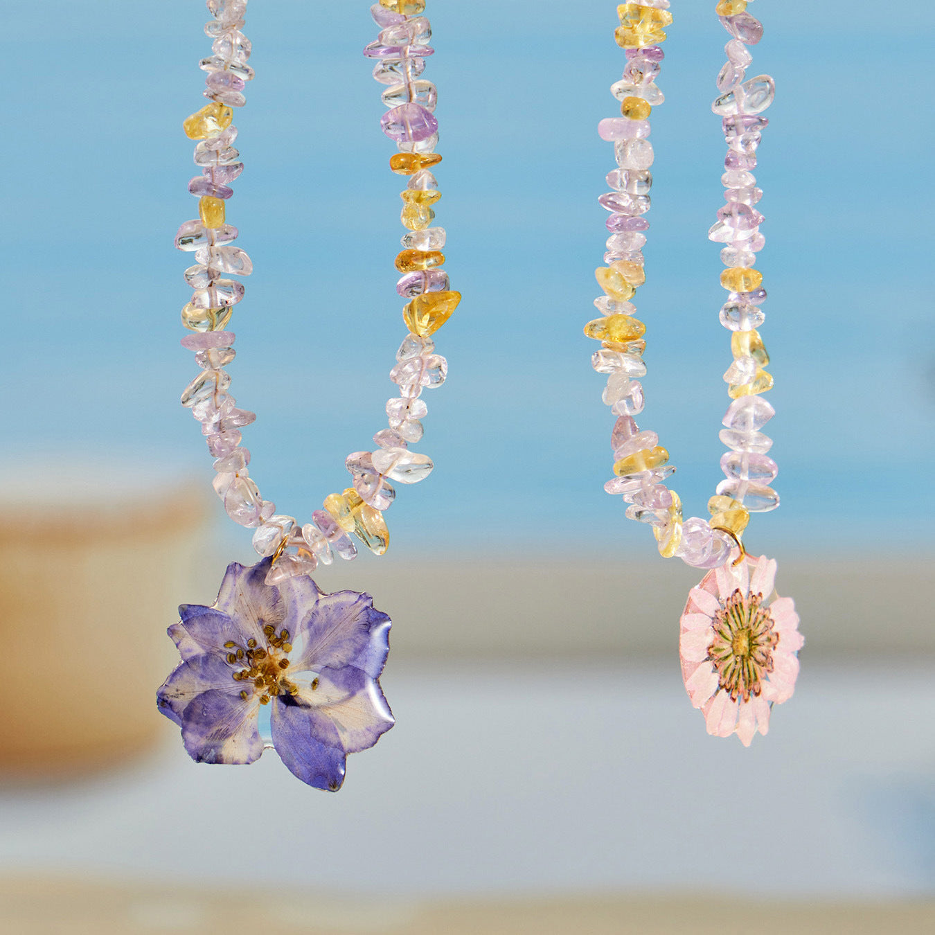 Resin flower crystal bead necklace collection with purple and pink floral pendants for wholesale boutique buyers