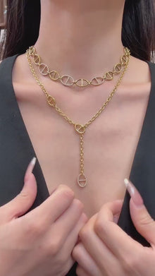 Video showcasing 316L stainless steel paperclip chain and Y-shaped lariat zircon necklace collection in 18K PVD gold and steel finishes
