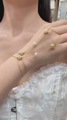 Video cover showing model wearing gold shell zircon pearl hand chain finger bracelet in 316L stainless steel summer ocean inspired jewelry by Miduoduo Jewelry