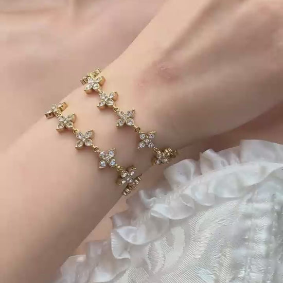 Video cover showing model wearing gold four leaf clover zircon adjustable sliding bracelet in 316L stainless steel by Miduoduo Jewelry