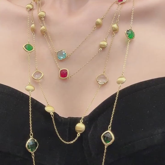 Colored glass stone station long necklace in 316L stainless steel with gold-tone beads, shown on model for wholesale jewelry buyers