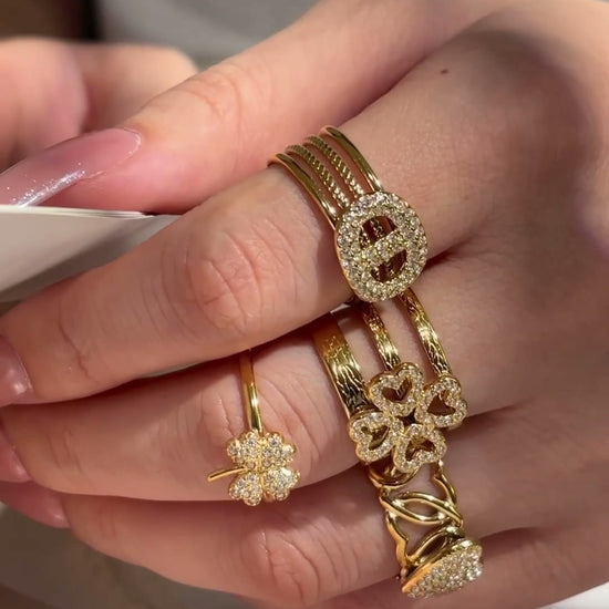 Model showcasing 316L stainless steel CZ open rings in floral heart and statement designs with 18K PVD gold finish