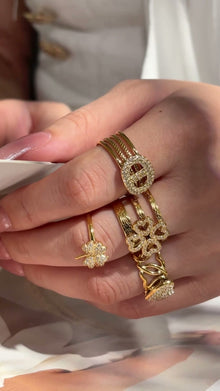 Model showcasing 316L stainless steel CZ open rings in floral heart and statement designs with 18K PVD gold finish